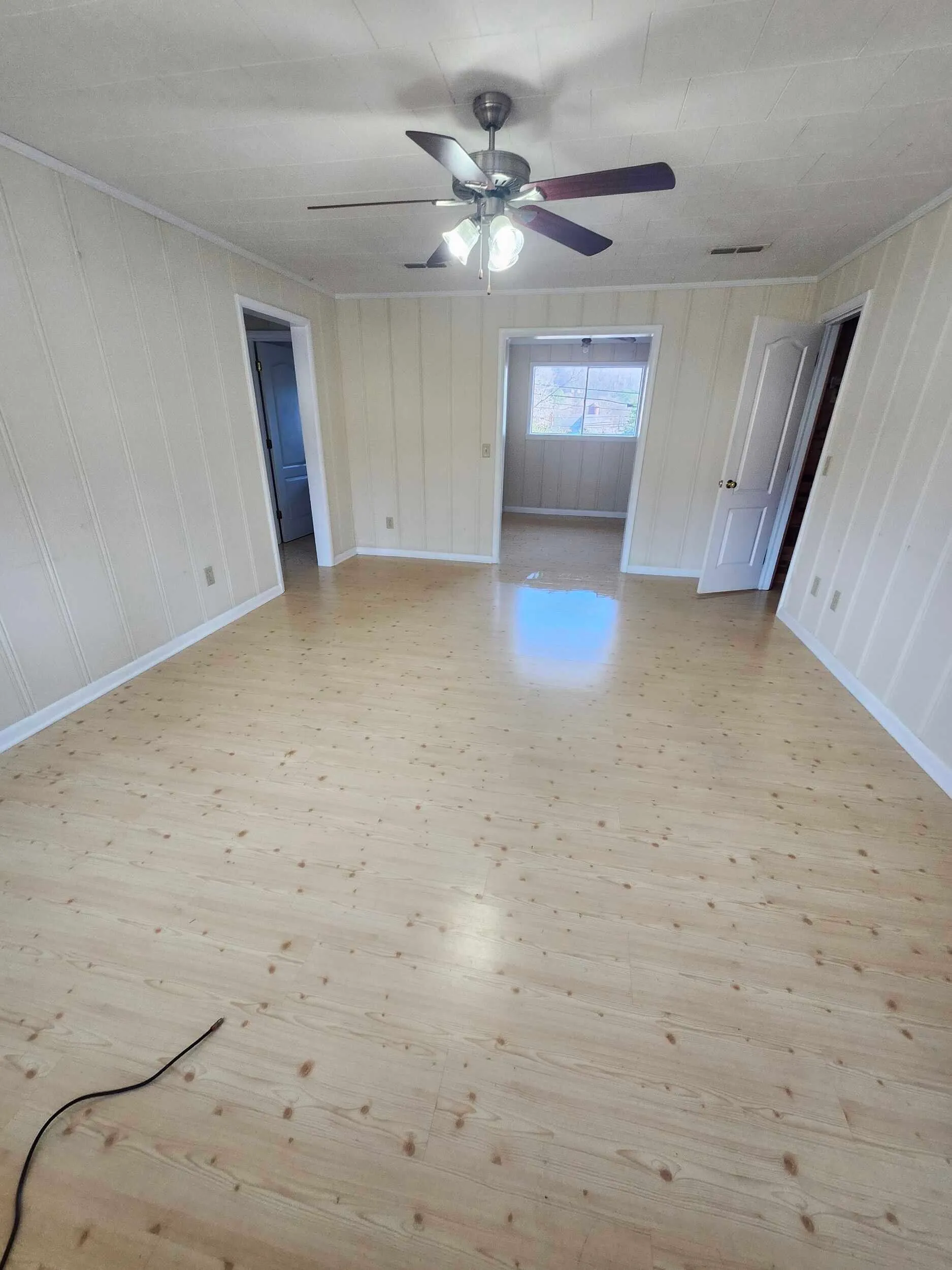 Brickstone Square bedroom with a high window and wood floors