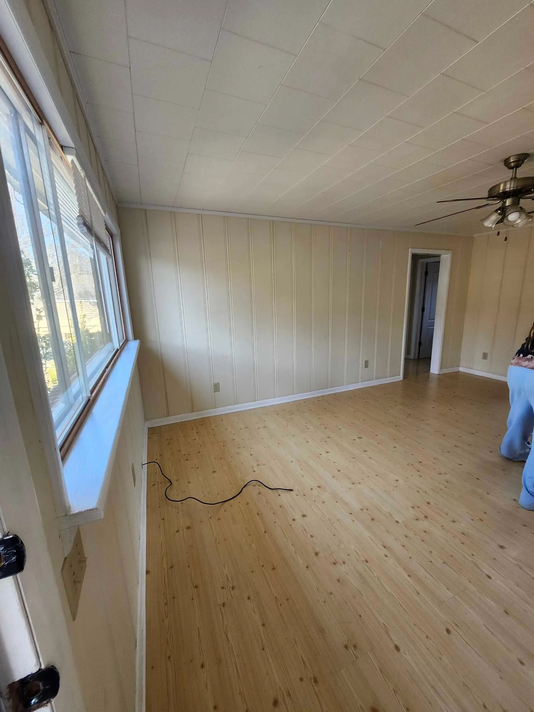 Brickstone Square room with a bright window wall and wood floors