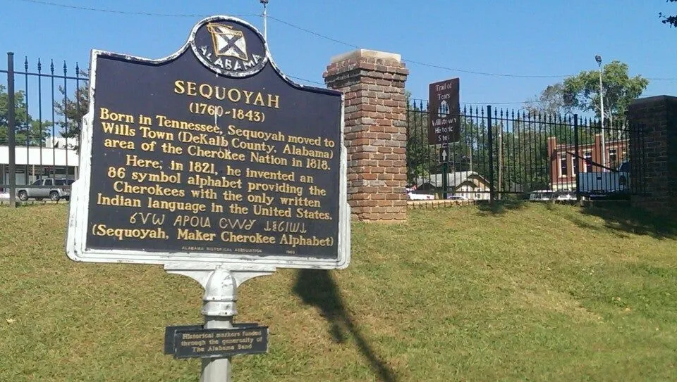 Historic Sequoyah sign set in a grassy area with hills behind it