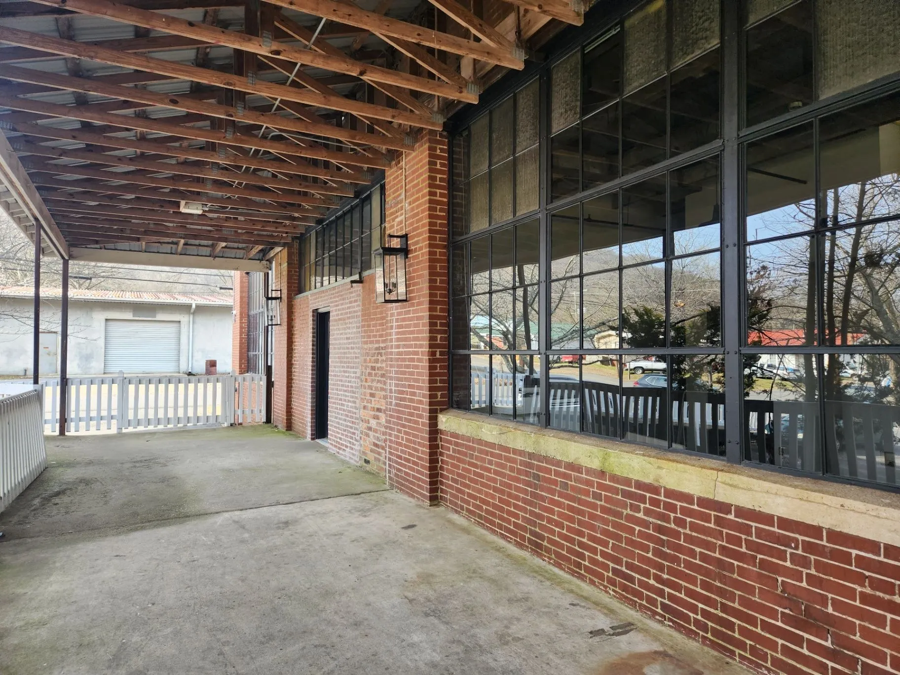 Covered Mill Town walkway with brick walls and large windows